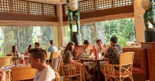 The pacific dining room features a blend of elegant and modern design elements with chandeliers, plush sofas and a large meeting or dining table. Restaurants Loews Royal Pacific Resort Universal Orlando