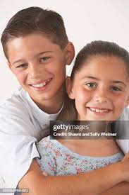 Portrait Of Brother And Sister Embracing High-Res Stock Photo