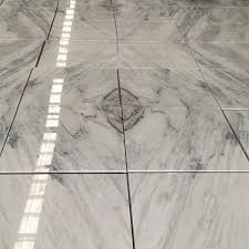 A floor is the bottom surface area of a room, apartment or any other space. China New Process Promotion White Nature Stone Sunny White Marble Tile For Floor Design China Marble Marble Tile