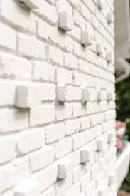 White painted exterior brick wall. Tips For Painting Your Exterior Brick A Beautiful Mess