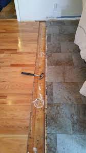 The designer has the tile ending in a full tile along a straight line. How Can I Create An Invisible Transition Between Different Flooring Types Home Improvement Stack Exchange