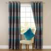 This casual living room and sunroom has bamboo curtain rods that extend around the perimeter of the room. 1