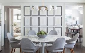 Glass top dining table with metallic base and retro elegance. 32 Dining Rooms With Unique Tables Chairish Blog