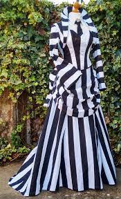 Jenner was wearing a long coat over a black and white striped dress. Beetlejuice Cosplay Costume Dress Medieval Dress Black And White Stripe Dress Beetlejuice Dress Medieval Dress White Striped Dress