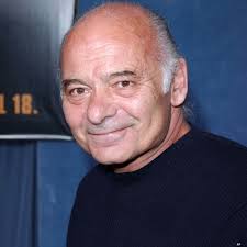 Love machine played by Burt young was Paulie in rocky that was made 2 years  previous. I've only just noticed it's got Paulie hauling in the side of his  truck.