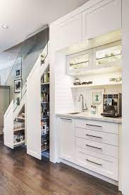 If you're building or renovating, you'll be making decisions around if you don't have a butler's pantry or even the 'standard' corner pantry cupboard, the best alternative is to remember when we spoke about dead space before, well the spot under the stairs is often one. Before And After See How This Home Added A Coffee Station And Food Storage Cabinet Under The Stairs Kitchen Under Stairs Stairs In Kitchen Cabinet Under Stairs