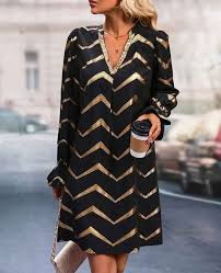 Women's black dress with gold accent print, notched neckline, long sleeve.  97%Polyester 3% spandex Machine wash See size chart for measurements