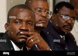 Daniel Delva, left, James Derozin, center, and Phelito Doran, of the  Lavalas party, listen during the national conference