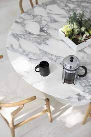 A round, wood table by pierre is a great option for a small dining room area. 11 White Marble Dining Tables We Love
