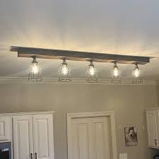 We offer light fixtures for every ambience. Farmhouse Beam Light With Cages Bulbs Included Farmhouse Ceiling Light Cage Light Kitchen Ceiling Lights