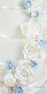Check spelling or type a new query. Cascading White And Powder Blue Roses On A White Wedding Cake Wedding Cake Roses Powder Blue Wedding Wedding Cake Fresh Flowers