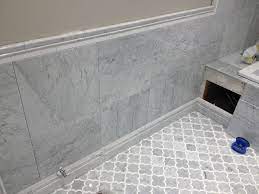 This article is about how to install baseboard trims with glue. Edmonton Tile Install White Marble Bathroom Marble Tile Bathroom Bathroom Baseboard Tile Bathroom