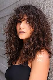 Long curly hair with bangs looks fantastic especially when you choose a fantastic color that suits your skin tone and defines your rick ringlets and curls. Long Hair With Bangs How To Choose Perfect Bangs For Your Face