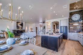 They maximize the appearance of space, and lend themselves in the context of the kitchen, an open concept floor plan is typically based around a kitchen that opens up to a dining room, a dining room and living. Open Concept Kitchen With Large Island And Dining Area Nearby Stock Photo Picture And Royalty Free Image Image 152883983