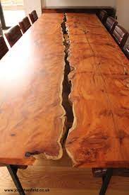 Two Slabs Of Yew With The Waney Edge Facing Inwards Are Held Just Apart On Black Steel Legs To Give A Soli Wood Slab Table Slab Dining Tables Wooden Slab Table