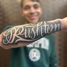 RUSHTON” The birthday boy grin! Stoked as to tattoo my homies son Ariki.  Well done to the mr Rushton's! #lettering #script #scripted #tat #arttattoo  #art #arm #chch #otautahi #ōtautahi #ccity #shaded #letters #
