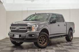 Black And Red Wheels For F150 F 150 Lift Level Kit Install With Bronze Fuel Wheels And Toyo R T Open Country Tires In Lead Foot Gray Ford Lifted T Fuel Wheels Ford Trucks F150 Lifted Trucks