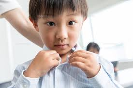 Preschooler waits patiently to go down slide
