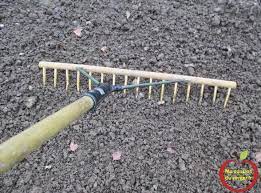 utiliser un rateau a foin avec un ecart de la denture pour niveller la terre pour semer gazon semer gazon gazon refaire
