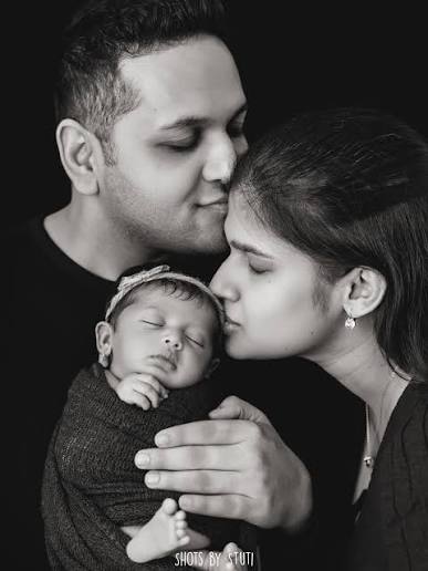 Monochrome Family Forehead Kiss Newborn Portrait