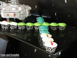 Selection of lego toy starwars characters strategically placed on and around the cake. Star Wars Light Saber Cupcakes Clean And Scentsible