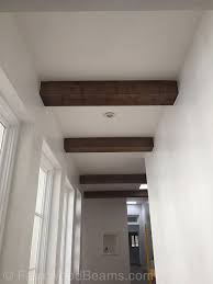 Exposed beams are popular in rustic as well as contemporary themed homes. The Look Of Natural Wood For Less Faux Wood Beams Faux Ceiling Beams Fake Beams Ceiling