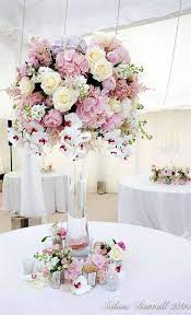 The materials and flowers used in your centerpieces are great launching points for the rest of your wedding decorations. 20 Truly Amazing Tall Wedding Centerpiece Ideas Wedding Floral Centerpieces Wedding Flower Trends Flower Centerpieces Wedding