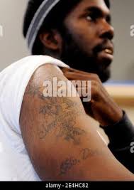 Sgt. Robert Samuel shows the tattoo he has done