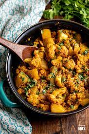 Delicious Aloo Gobi A Popular Vegetarian Dish Of Potatoes And Cauliflower Coated In Delicious Indian Spices T Aloo Gobi Vegetarian Dishes Indian Side Dishes