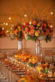 Bright centerpiece of fuchsia dahlias and orange carnations. Fall Wedding Inspirations Wedding Flower Centerpieces Tall Orange Wedding Flowers Fall Wedding Centerpieces