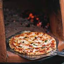 Wood Fired Pizzas With Salami Basil Recipe Wood Oven Pizza Wood Fired Oven Recipes Wood Fired Pizza