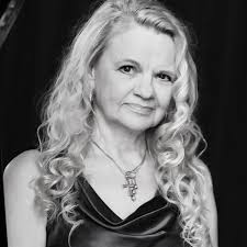 August Blue by Deborah Levy A gifted pianist, Elsa arrives in Athens, where  she sees a mysterious women buying toy horses at a souvenir stall. Who is  this person and why does