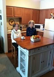 Homestyles Americana Distressed Cottage Oak Kitchen Island With Drop Leaf 5004 94 The Home Depot Drop Leaf Kitchen Island Oak Kitchen Walnut Kitchen Island