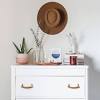 Soften things up with a small round nightstand, like this one. 3