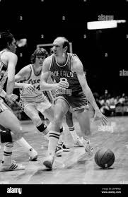 Bob Weiss (8) of the Buffalo Braves runs out of room as 76ers' guard Doug  Collins blocks his way to the basket in the first half at night, Monday,  Jan. 7, 1975