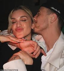 Ashley Roberts, 42, goes Instagram official with toy-boy George Rollinson,  25, as artist plants a kiss