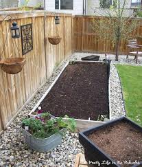 river rock around raised garden bed backyard garden garden yard ideas