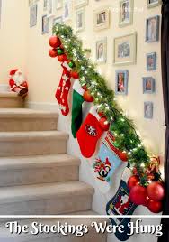 Cordless banister garland celebrates the lush emerald tones of an evergreen medley. Festive Way To Hang Stockings On A Stair Railing Across The Blvd