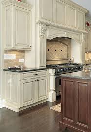 Prasada Antique White Kitchen With Large Decorative Range Hood Walnut Island Design Antique White Kitchen Antique White Kitchen Cabinets Kitchen Range Hood