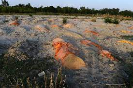Near the river bank on the ghat, the indian express found hundreds of burial spots lying exposed after the rains. L4fgza2gv 5kfm