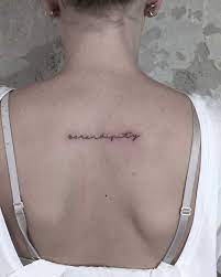 Word Serendipity Tattooed In A Handwriting Font On The Upper Back Serendipity Tattoo Tattoos Ribcage Tattoo