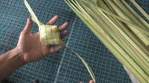 It is made by wrapping rice in woven coconut leaves and then boiled until it is cooked. How To Weave Ketupat Casing Youtube