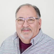 Kayla Digby, President of Voyager Express, located in Denver, CO, accepts  an appreciation plaque for inviting Marketplace Cares to serve the  employees and drivers of Voyager Express.