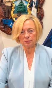 Could one of you clever lot please make the lady in pink slimmer...  especially around the tummy. She was most upset how this pic turned out😢.  Thank you. Update. Thank you so