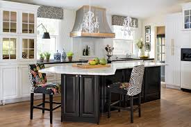 White cabinets, walls, and a kitchen island with breakfast bar and stools in the kitchen space are broken up by a fine medium brown wood island top. Our Favorite Kitchen Island Seating Ideas Perfect For Family And Friends Better Homes Gardens