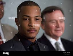 Rapper T.I., who's real name is Clifford Harris,stands for a press  conference with attorneys Dwight Thomas, left, and Ed Garland, right, after  being sentenced to one year and one day