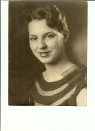 Katrina Parker standing at the main doors of the School Gymnasium.