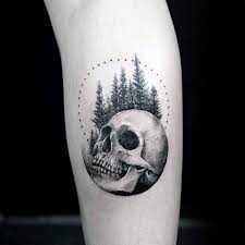 Skull With Trees And Circle Mens Small Detailed Tattoo On Leg Small Skull Tattoo Detailed Tattoo Tattoos For Guys