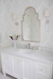 This minimal, rustic bathroom makes the best out of the least amount of decor possible, with a wooden ladder for the towels, a concrete floor, and open wood vanity. 19 Beautiful Wallpapered Bathrooms