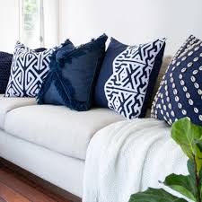 Textural throw pillow featuring shag tufting in a geometric design and slub weave, complete with chunky tassel trim at sides. Cross Fringe Navy Lounge Cushion Interiors Online